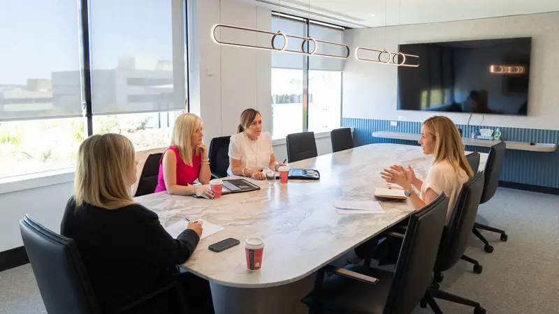 The Brand Barristers & Solicitors team in a conference room meeting