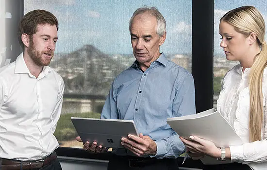 The Mahoneys Lawyers team reviewing documents in an office