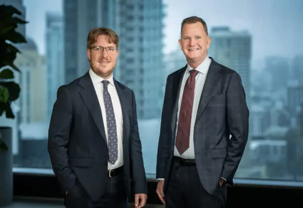 The Thynne + Macartney team in an office with city skyline view